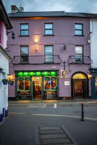 a purple building with a store on a street at Number One Townhouse in Kinsale