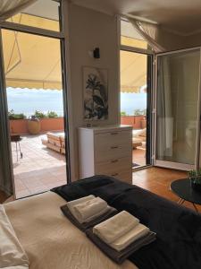 a bedroom with a bed with two towels on it at Casa Della Baia With a beautiful view in Varazze +51 photos