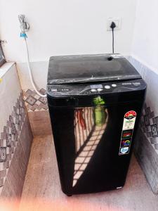 a black trash can sitting on the floor in a room at Indigo Homes Kondapur in Hyderabad