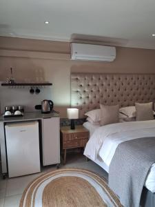 a large bedroom with a large bed and a table at Bohemian Guesthouse - Pretoria in Pretoria