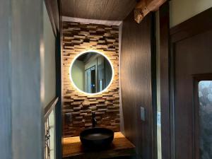 a bathroom with a black sink and a mirror at 宮島 Shinwa in Miyajima
