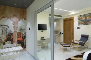 a living room with a sliding glass door at Dwarka Palace in Hingoli