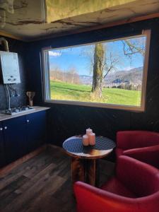 a small room with a table and a window at Le Nid Douillet du Tacot in Le Thillot