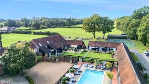 an aerial view of a house with a swimming pool at Eagle's Nest in Worplesdon