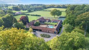 an aerial view of a house with a pool at Eagle's Nest in Worplesdon