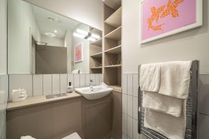 a bathroom with a sink and a mirror at Number One Townhouse in Kinsale +49 photos
