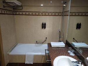 a bathroom with a tub and a sink and a mirror at Mirador del Cabo Designed For Adults in Aguadulce +36 photos