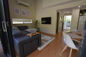 a living room with a couch and a table at Sea Renity Preston Beach in Preston Beach