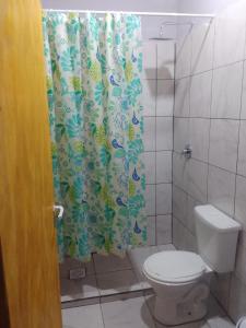 a bathroom with a toilet and a shower curtain at Departamento Monoambiente-Selva Stay Iguazu in Puerto Iguazú +43 photos