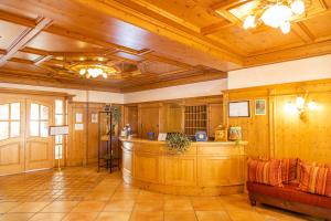 a large room with wooden ceilings and a bar in it at Hotel Residence Panorama La Forca, GTSGroup in Tignale