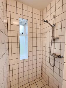 a bathroom with a shower with a window at Eiðar - Apartments in Eiðar +104 photos