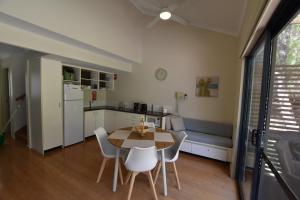a kitchen and dining room with a table and chairs at Sea Renity Preston Beach in Preston Beach +6 photos