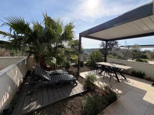 a patio with a table and chairs and a table and ailion at Apartman SeaSide 8 in Banjole