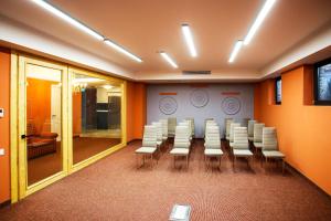 a conference room with a table and white chairs at Magnolia Tbilisi in Tbilisi City
