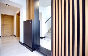 a hallway with a black and white striped wall at Tlenoterapia in Białystok