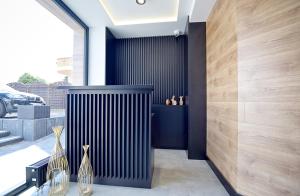 a black radiator in a room with wooden walls at Tlenoterapia in Białystok +1 photo