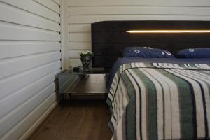 a bedroom with a bed and a side table at ON2 Bungalov Villas 2 in Antalya