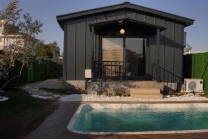 a tiny house with a pool in front of it at ON2 Bungalov Villas 2 in Antalya