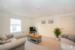 a living room with a couch and a coffee table at Minster's Keep- Near York Minster & Free Parking in York