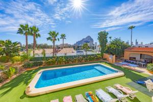 an image of a swimming pool in a yard with chaise lounge chairs at Villa Cronos - PlusHolidays in Ifach