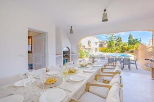 a dining room with a long table and chairs at Villa Cronos - PlusHolidays in Ifach