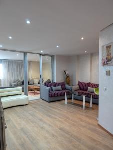 a living room with two couches and a room with at Tanger City 5 in Tangier