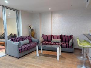 a living room with two couches and a table at Tanger City 5 in Tangier