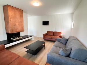 a living room with a couch and a table at Eiðar - Apartments in Eiðar