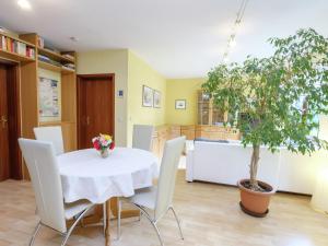 una sala da pranzo con tavolo, sedie e un albero di Beautiful apartment in the Harz with terrace a Ballenstedt
