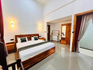 a bedroom with a large bed in a room at Coral Bay Villa in Pottuvil
