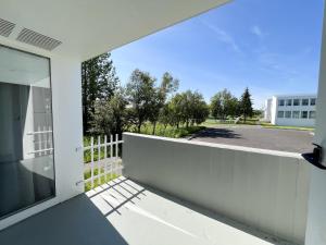 a balcony with a view of a parking lot at Eiðar - Apartments in Eiðar