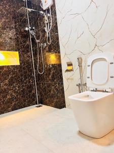 a bathroom with a toilet and a shower at Coral Bay Villa in Pottuvil +60 photos