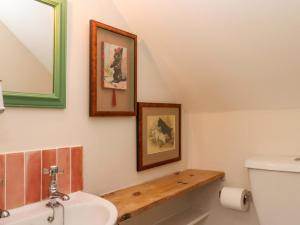 a bathroom with a sink and a toilet and a mirror at Old Sunday School in Bideford +41 photos