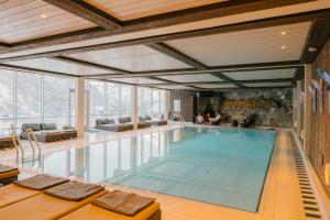a large swimming pool in a large building at Hotel Union Geiranger Resort & Spa in Geiranger