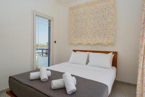 a bedroom with a bed with towels on it at The Marina View in Lavrio