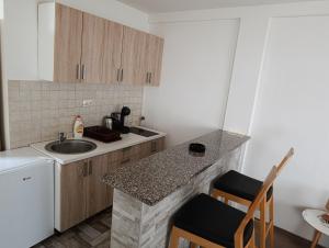 a small kitchen with a sink and a counter at Moskva Apartman in Brčko