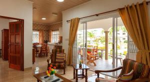 a living room with a large glass door to a patio at Belle Vacance in Grand Anse