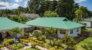 an aerial view of a house with a green roof at Belle Vacance in Grand Anse