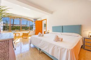 a bedroom with a large bed with two pillows on it at Villa Cronos - PlusHolidays in Ifach