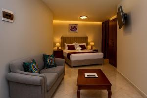 a hotel room with a bed and a couch at Juba Landmark Hotel in Juba
