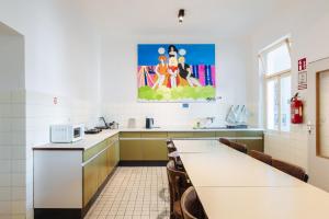 a kitchen with a table and chairs in a room at NUMBR25 - self service & low budget Hotel in Graz
