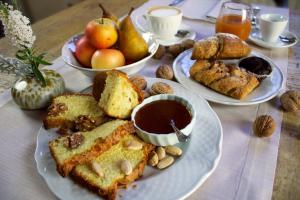 a table with three plates of bread and fruit and nuts at Terra dei Bisonti in Panicale +52 photos