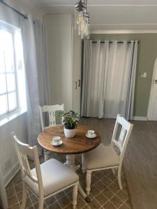 a dining room with a wooden table and chairs at Maple and Vine in Hilton