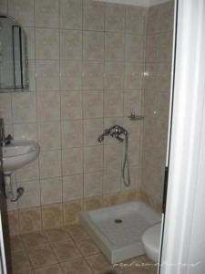 a bathroom with a shower and a toilet and a sink at Psaros Melinta in Plomari