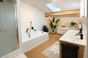 a bathroom with a sink and a bath tub at Scandinavian Alpine Lodge nahe Tegernsee - stilvoll & ruhig in Reichersbeuern +37 photos