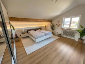 a large bedroom with a bed and a window at Scandinavian Alpine Lodge nahe Tegernsee - stilvoll & ruhig in Reichersbeuern