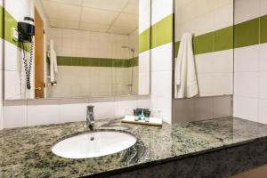 a bathroom with a sink and a mirror at Hotel de l'Isard in Andorra la Vella +46 photos