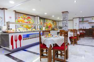 a restaurant with a table and chairs and a counter at Hotel El Tajo & SPA in Ronda