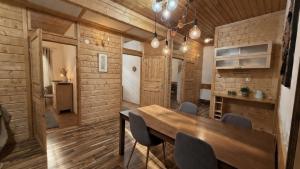 a dining room with a wooden table and chairs at Lumi Guest House in Arvidsjaur