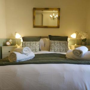 a bedroom with a large bed with towels on it at The Postgate Inn in Egton